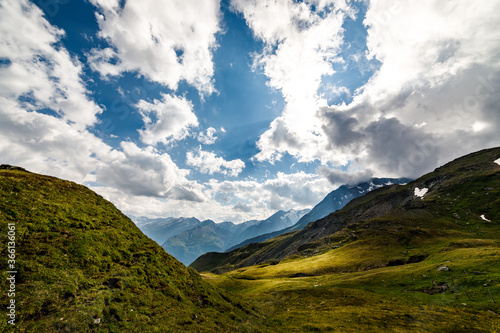 spectacular colorful view of mountain landscape with clouds and blue sky at the Grossglockner and the High Alpine Road in the austrian alps