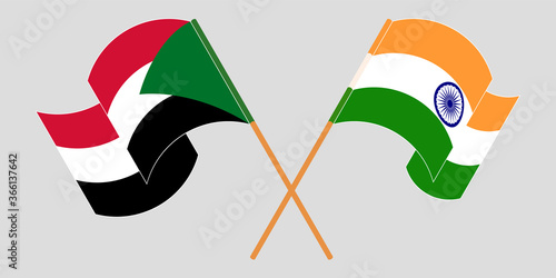 Crossed and waving flags of Sudan and India
