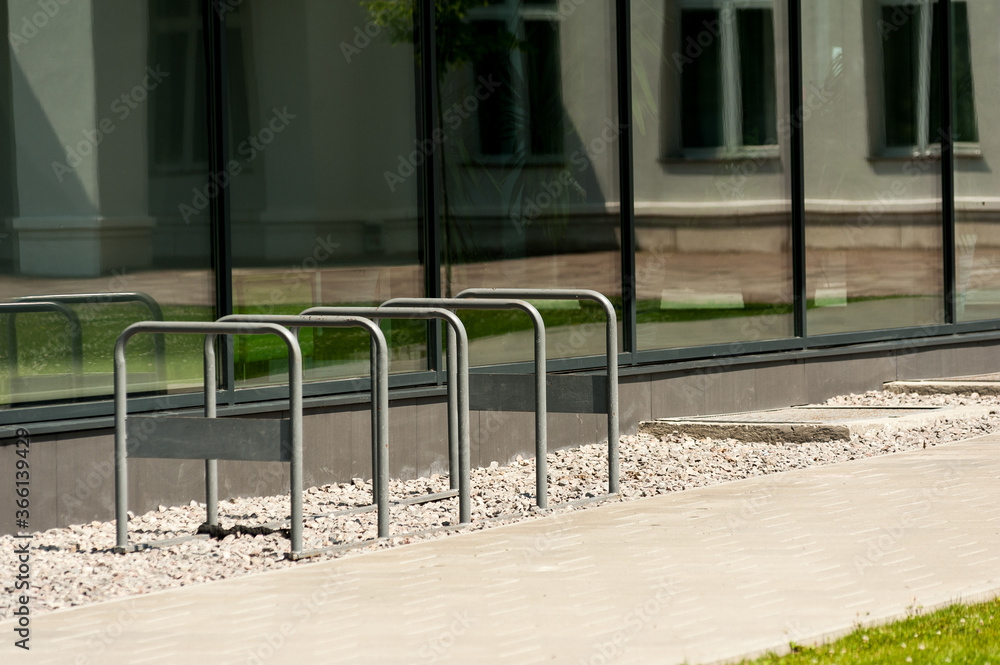 Bicycle park for office workers. Metal handrail bicycle parking near the office Bicycle park for office workers. Metal handrail bicycle parking near the office