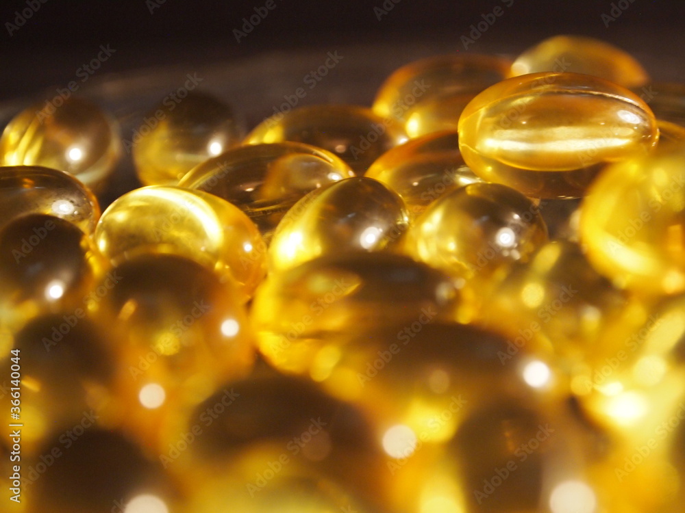 Trans-lucid cod liver oil pills under colourful light Trans-lucid cod liver oil pills under colourful light