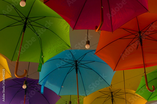 Colorful umbrellas background. Colorful umbrellas on the ceiling. Street decoration.