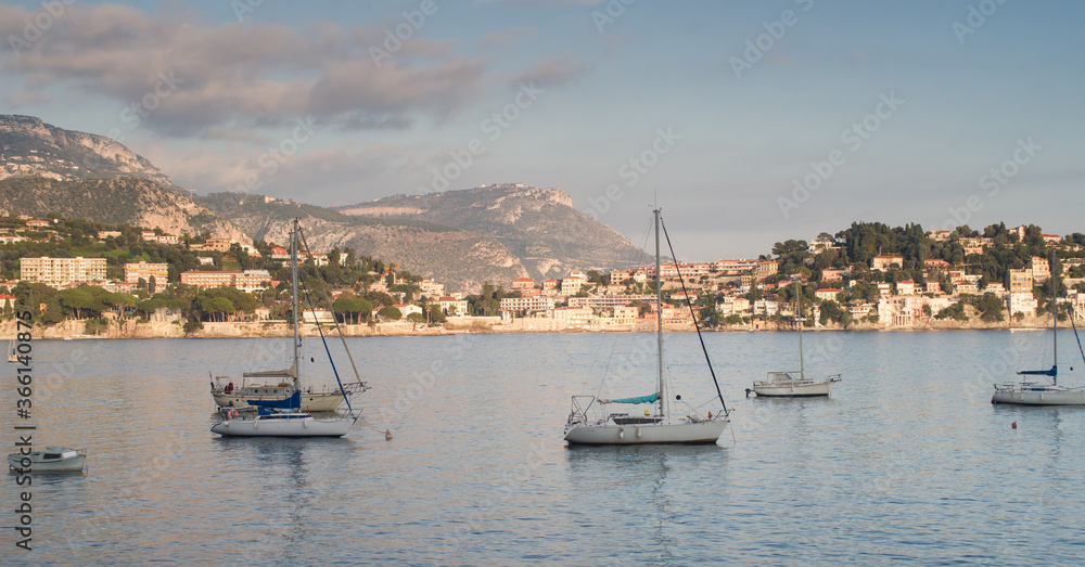 Sailing boats at sunset on villefranche in French riviera