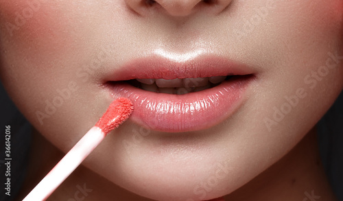 Close-up of female lips with lipstick. Lip makeup cosmetics.