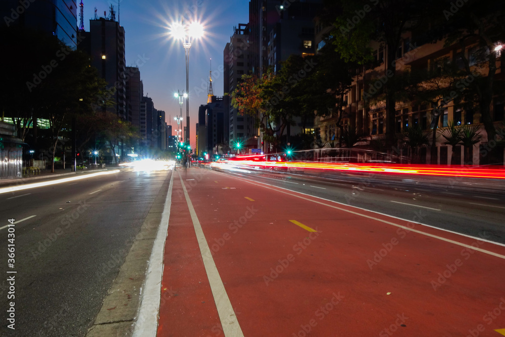Paulista avenue in Sao Paulo city, at night. Light trails and buildings