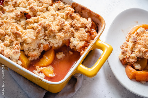 Peach cobbler dessert in a baking dish photo