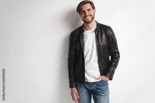 Fashion man, Handsome serious beauty male model portrait wear leather jacket, young guy over white background © opolja