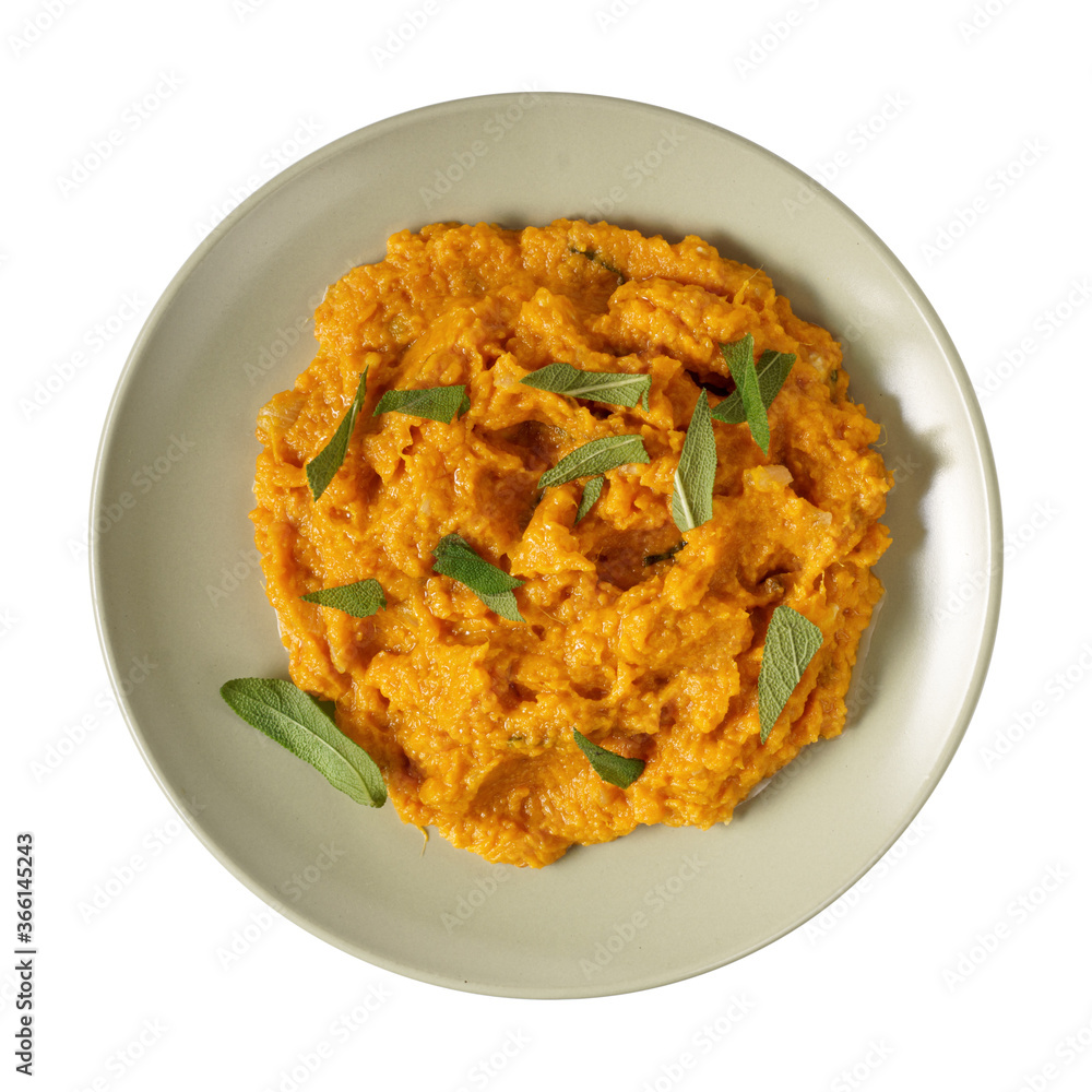 Mashed sweet potato with brie, sage and caramelized onions isolated top view