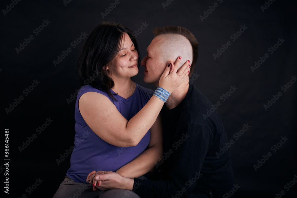 Portrait of mixed race couple in the studio. Two people together hug. Portrait of mixed race couple in the studio. Two people together hug.