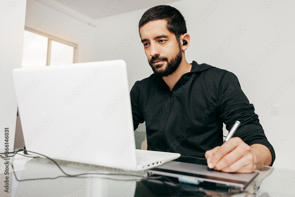 Designer working from home using laptop and tablet. Designer working from home using laptop and tablet.