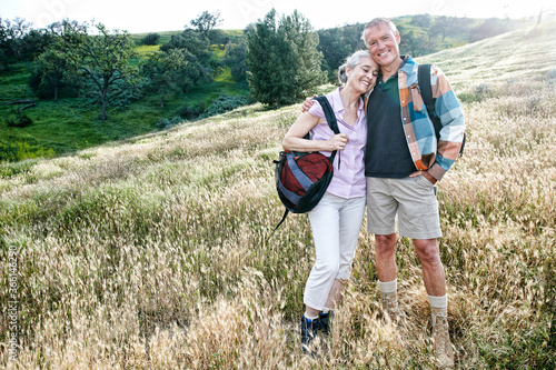 Caucasian couple smiling on hillside