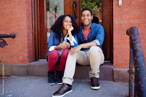 Smiling couple posing on front stoop photo