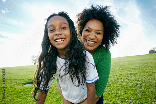 Portrait of smiling mixed raced mother and daughter photo