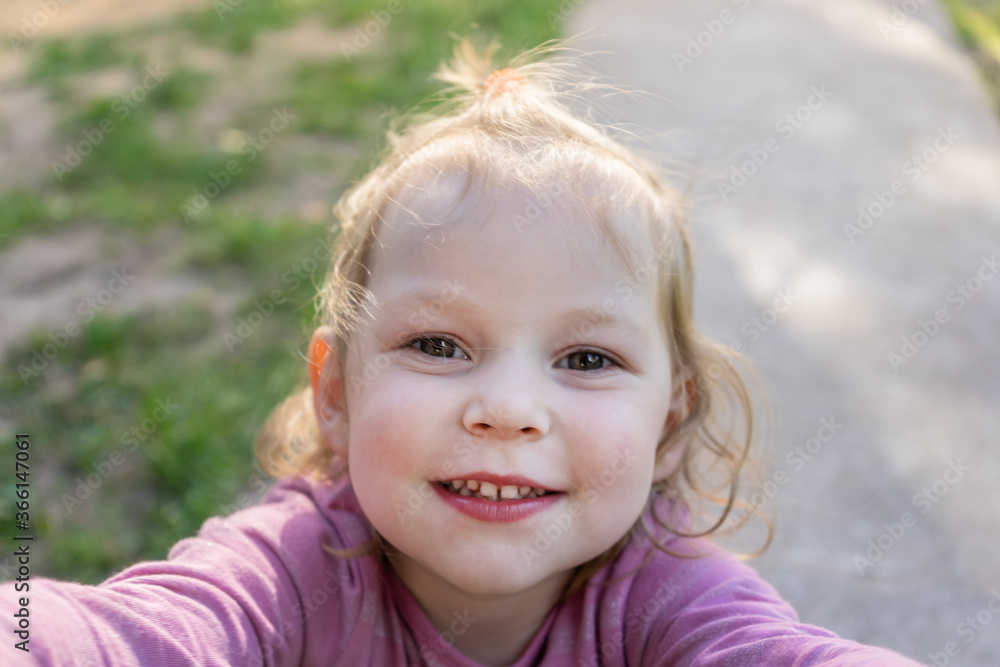 Little blond baby girl looking at the camera and smiling. Little blond baby girl looking at the camera and smiling.