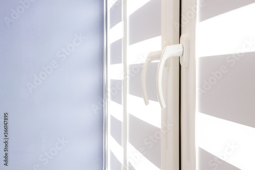 closed window or door with metal jalousie. Office meeting room lighting range control.