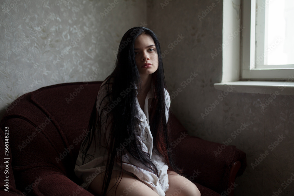 Portrait of young woman sitting in armchair Portrait of young woman sitting in armchair