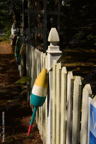 fishing bouys on a fence photo