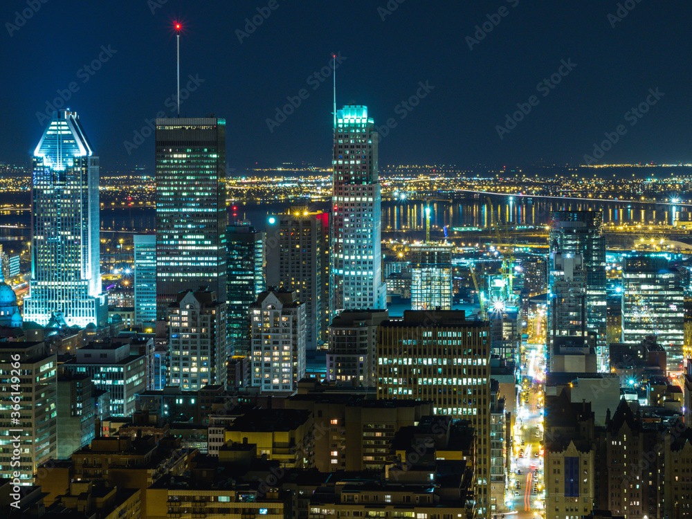 high view of a city at night with lots of lights and colors in summer