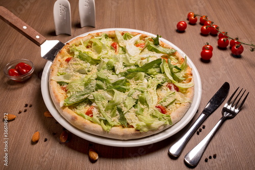 Caesar pizza thin cake, Caesar sauce, chicken fillet, tomatoes, mozzarella, parmesan, iceberg