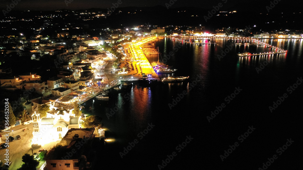 Aerial drone night shot of picturesque illuminated promenade area of Porto Heli fjord village, Argolida, Peloponnese, Greece