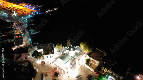 Aerial drone night shot of picturesque illuminated promenade area of Porto Heli fjord village, Argolida, Peloponnese, Greece