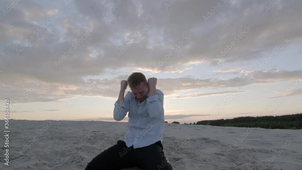 handsome dancer performs a freestyle dance composition on the sandy beach at sunset. Contemporary choreography. Emotions. Slow motion footage. Gimbal shot handsome dancer performs a freestyle dance composition on the sandy beach at sunset. Contemporary choreography. Emotions. Slow motion footage. Gimbal shot