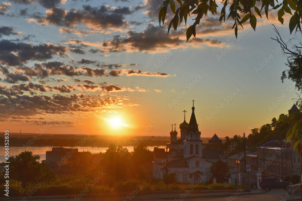 Fototapeta premium Christian church on the banks of the Volga River at dawn. Nizhny Novgorod