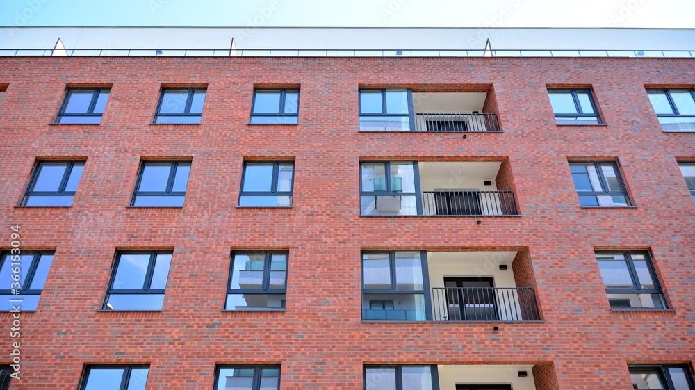 Modern apartment buildings on a sunny day with a blue sky. Facade of a modern apartment building. Glass surface with sunlight. Modern apartment buildings on a sunny day with a blue sky. Facade of a modern apartment building. Glass surface with sunlight.