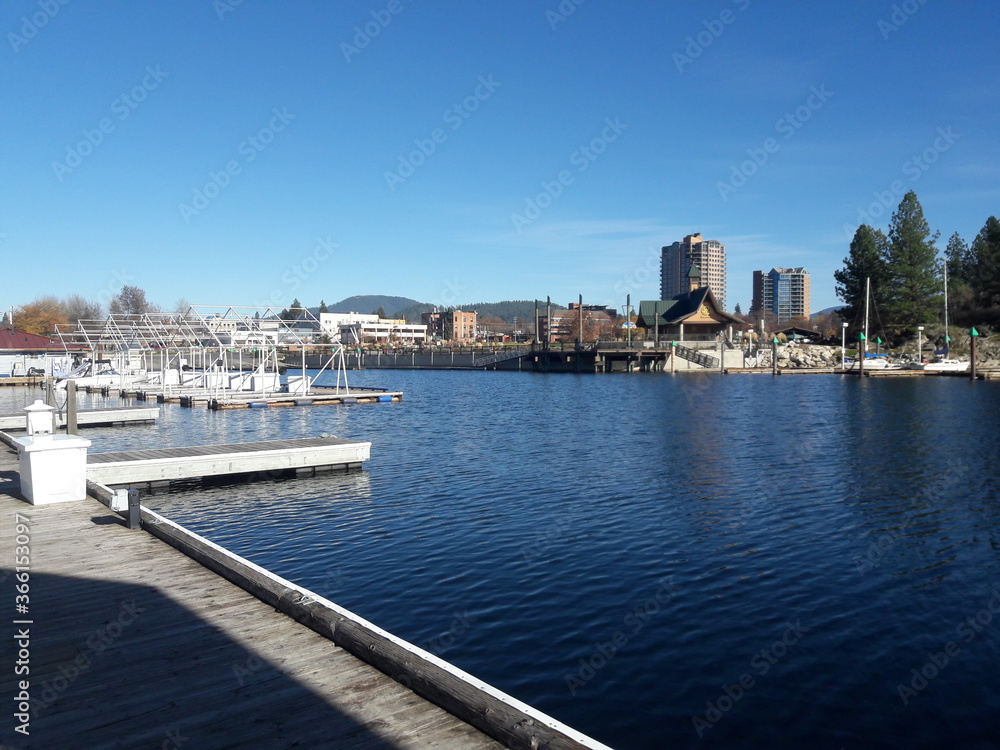 Marina with boats and airplanes docked on lake