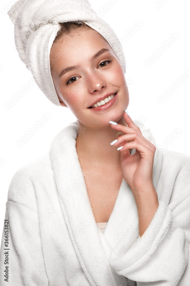 Beautiful tender young girl in a white towel with clean fresh skin posing in front of the camera. Beauty face. Skin care. Beautiful tender young girl in a white towel with clean fresh skin posing in front of the camera. Beauty face. Skin care.