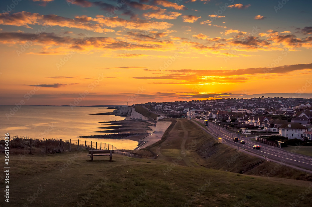 A view of the sunset from Saltdean looking towards Brighton, UK in summer