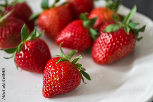 Juicy fresh strawberries on a white plate