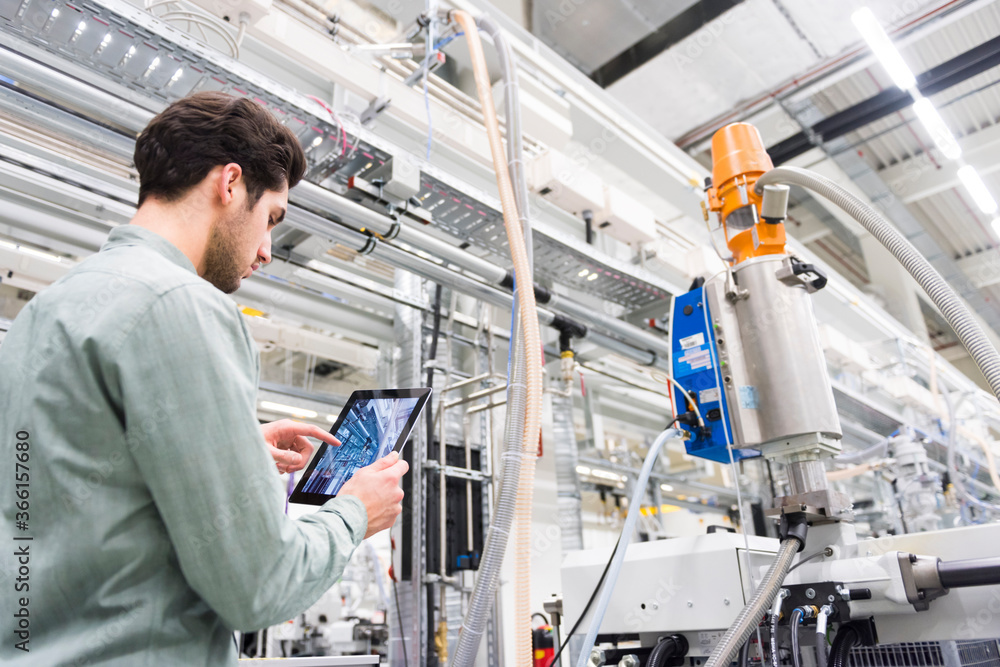 Man using tablet in a factory Man using tablet in a factory