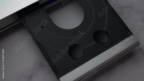 Top View DVD Disc, Eject Tray And Insert Disc In DVD-player. Man Of Hand Loads Disc Into The Device DVD/CD Player.