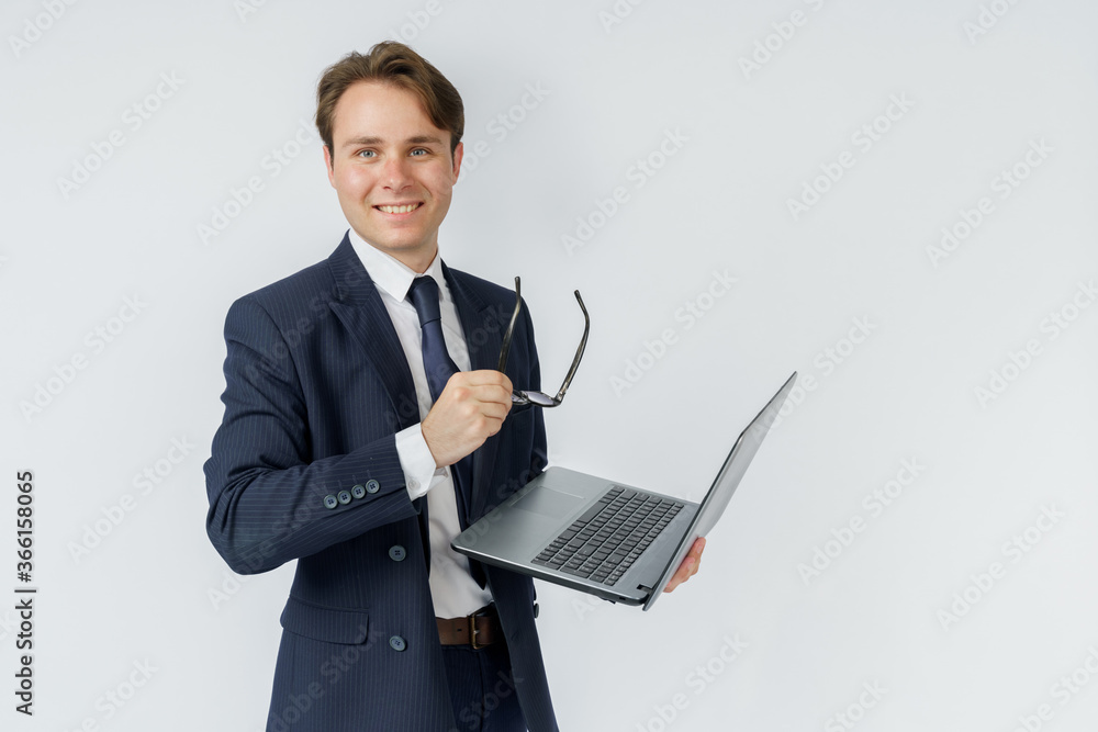 Portrait of a businessman who is holding a laptop and glasses. White background. Portrait of a businessman who is holding a laptop and glasses. White background.