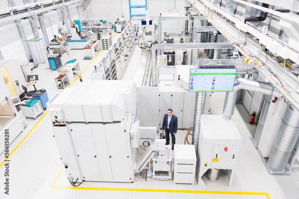 Businessman standing in a factory Businessman standing in a factory