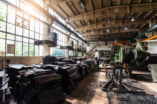 Senior businessman in a rubber processing factory