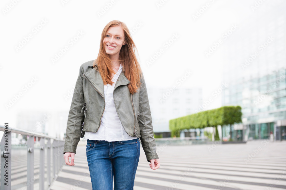 Portrait of smiling young woman in the city Portrait of smiling young woman in the city