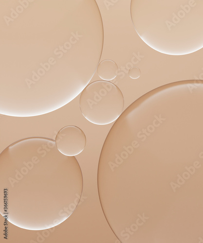 Three dimensional render of transparent glass spheres against light brown background