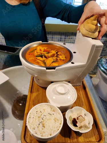 Food in a toilet bowl style plate
