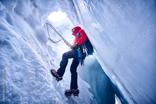 Mountaineer climbing in crevasse, Glacier Grossvendediger, Tyrol, Austria