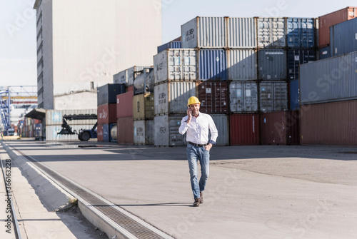 Businessman on the phone at industrial site