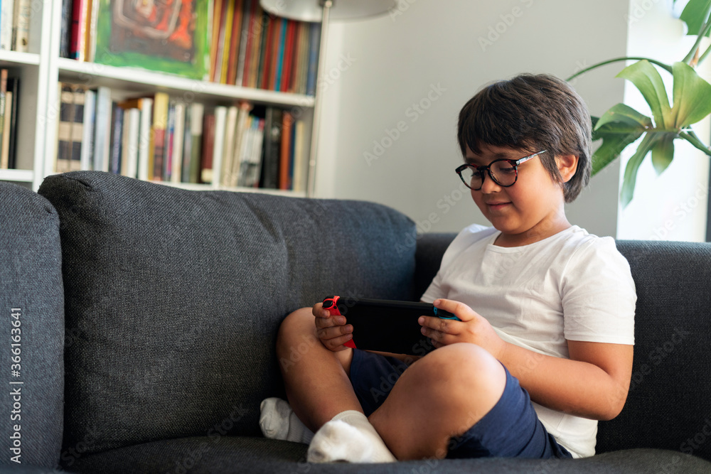 Boy playing video game on a games console Boy playing video game on a games console