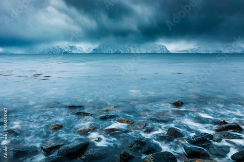 Cloudy atmosphere at the coast in winter, Fjord Lyngen, Skibotn, Norway photo