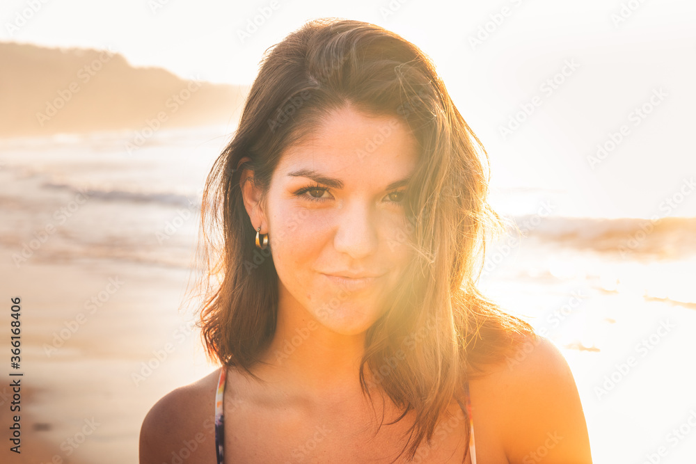 Young caucassian girl with a colorful bikini possing at the beach next to the sea. Young caucassian girl with a colorful bikini possing at the beach next to the sea.