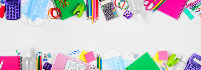 School or office supplies and coronavirus prevention items. Top view double border on a white background.