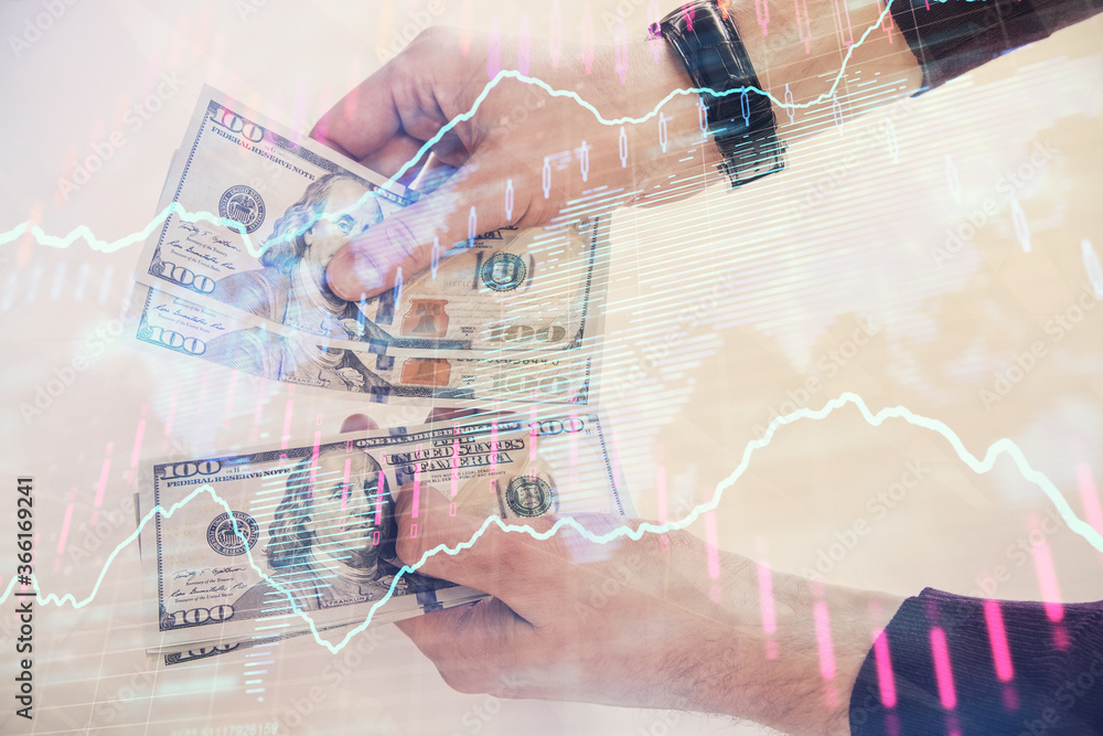 Multi exposure of financial graph drawing hologram and USA dollars bills and man hands. Analysis concept. Multi exposure of financial graph drawing hologram and USA dollars bills and man hands. Analysis concept.
