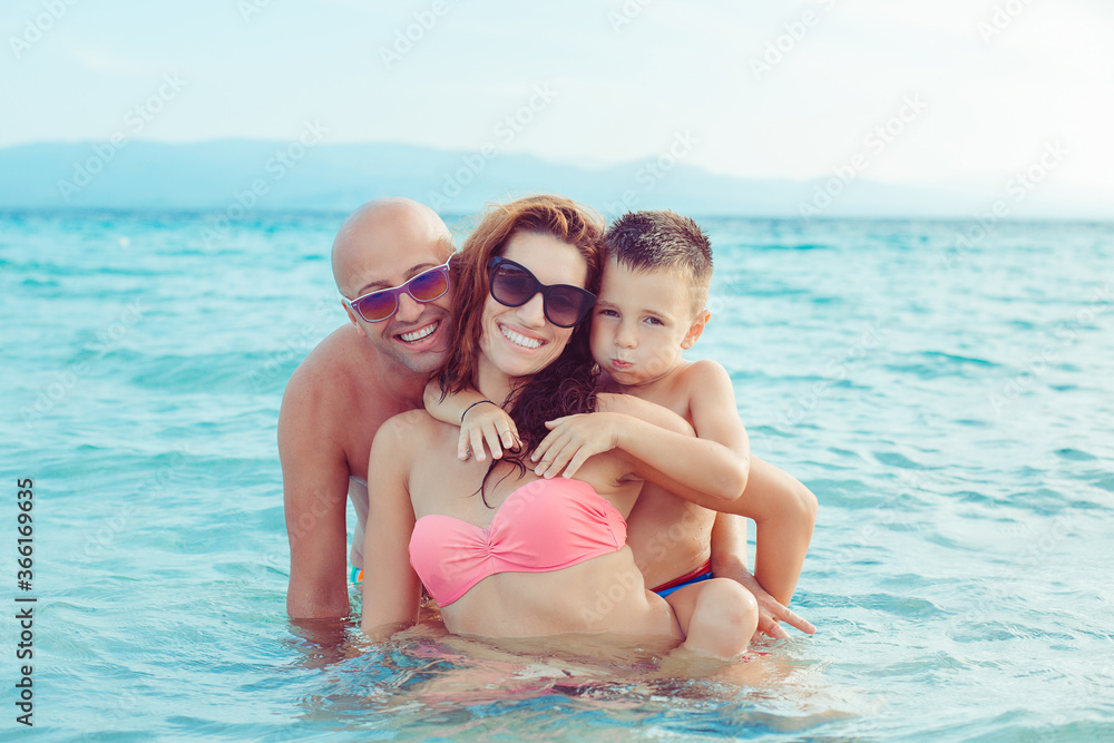 Cute Family on the beach having fun together