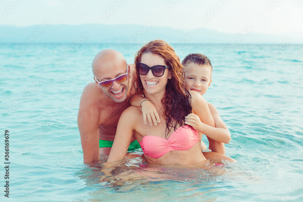 Cute Family on the beach having fun together Cute Family on the beach having fun together