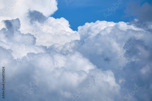 Large white clouds with thunderstorms in the blue sky