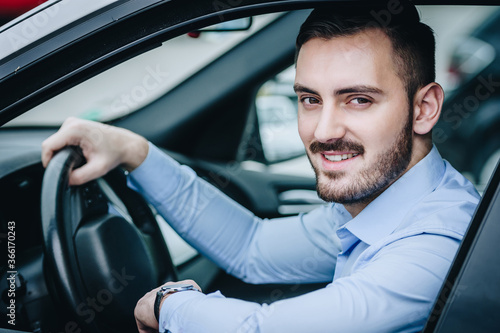 Happy man sitting in luxury car posing © Denis
